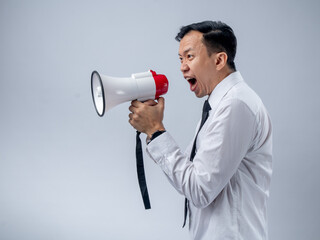 Asian businessman in white shirt and black tie enthusiastically holding a megaphone, speaking or announcing with a joyful expression, standing against a plain light background