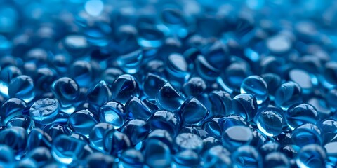 Closeup of blue translucent plastic pellets used in polymer manufacturing. Concept Polymer Manufacturing, Blue Translucent Pellets, Closeup Photography