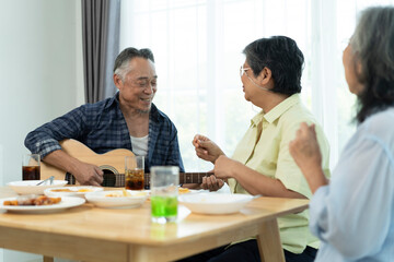 Three Senior friends bonding over music, singing and laughter in party