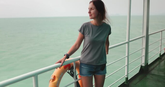 A woman standing on a boat in Thailand, ferry from Surat Thani to Koh Phangan Island