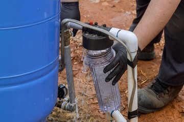 Worker performs maintenance work to replace filter in domestic water treatment system