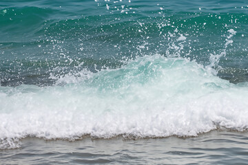 Obraz premium Waves splashing in the water. Wave ocean splash concept. White waves with splashes of water in the sea. A man splashes white water with waves in the lifestyle sea.