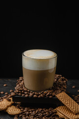 Cup of cappuccino on a dark background. Coffee drink