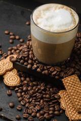 Cup of cappuccino on a dark background. Coffee drink