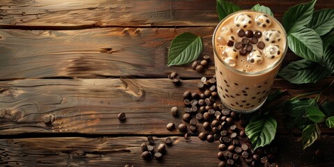 Glass of bubble tea on a rustic wooden table surrounded by tea leaves and tapioca pearls.