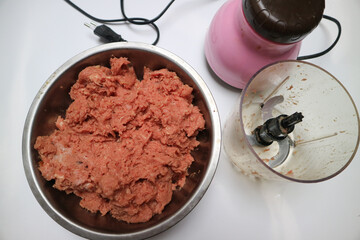 mixing raw ground beef mixture preparing to make fresh meatball, gourmet hamburgers, or another food meal. With ice cubes.