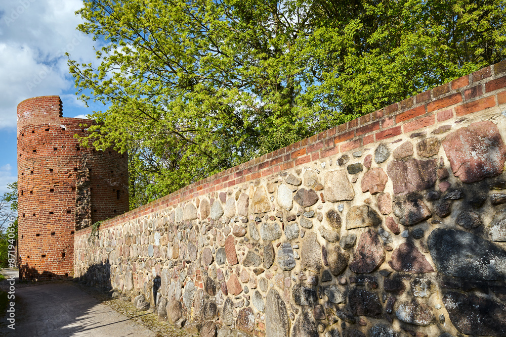 Sticker medieval fortifications with a brick tower and a stone wall in Prenzlau