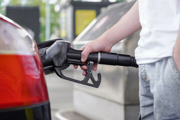 A driver fills a car with fuel at a gas station.