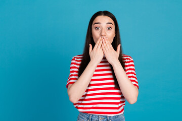 Photo of shocked attractive lady dressed red t-shirt arms cover mouth empty space isolated blue...