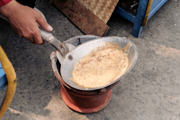 a typical food from betawi the province of DKI Jakarta, Indonesia made from eggs and sticky rice usually called kerak telor, being cooked in the traditional way