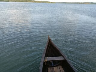 A canoe is a lightweight narrow water vessel, typically pointed at both ends and open on top, propelled by one or more seated or kneeling paddlers facing the direction of travel and using paddles.