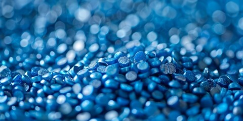 Small shiny blue plastic granules of various shapes for eco-friendly recycling. Concept Eco-Friendly Granules, Plastic Recycling, Shiny Blue Material, Small Shapes