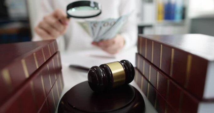 Judge or lawyer examines money through magnifying glass in courtroom. Counterfeiting crimes and criminal penalties. Coin authentication concept