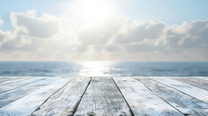White horizontal wooden table top With a blurry background of the sea and sky. 