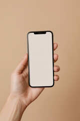 close up of hand hold mobile phone on beige background studio shot