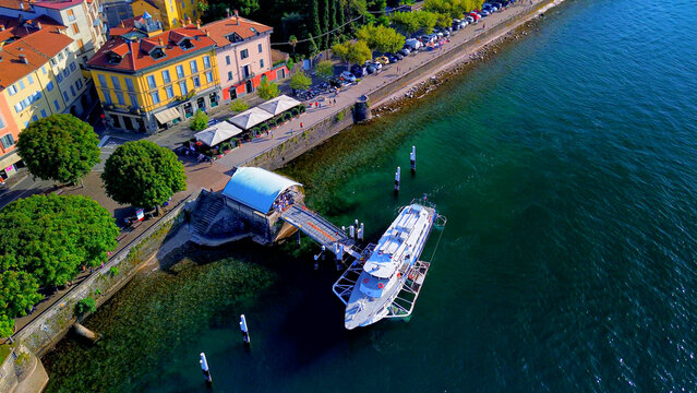 Aerial view of Lake Como. city ​​center. Bell tower. Tourism and romance. Mountains around the lake. Red roofs. Green Planet. Sailing yacht. Powerboat. travel to Italy, Bellano, 12.07.2024