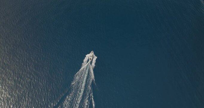 Aerial view of boats navigating the turquoise waters along the coastline of Salina Island, Sicily, Italy.