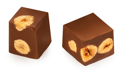 Cubes of milk chocolate bar with hazelnuts isolated on white background.