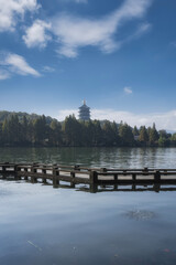Serene Lakeside Pagoda with Pier and Blue Sky