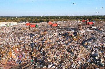 Garbage truck unloads rubbish in landfill. Landfill with waste disposal, Garbage dump. Reduce...