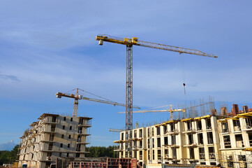 Construction site. Construction of Residential Building. Tower Crane on formworks. House Construction and Residential Building. Tower Cranes on Residential buildings Construction. Housing, renovation.