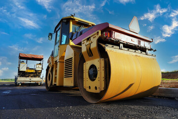 Road Construction. Asphalt road roller on highway construction. Vibration roller compactor on press...