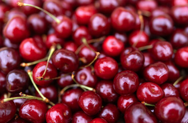 Cherry background, texture. Lots of cherries, top view. Cherry for background and screensaver. Cherry berry wallpaper, background. Bunch of red cherries.