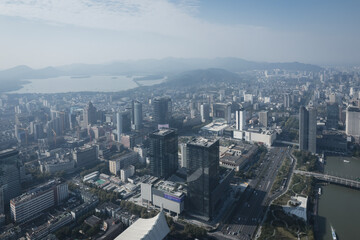 Fototapeta premium Aerial View of Urban Cityscape with Lake and Mountains