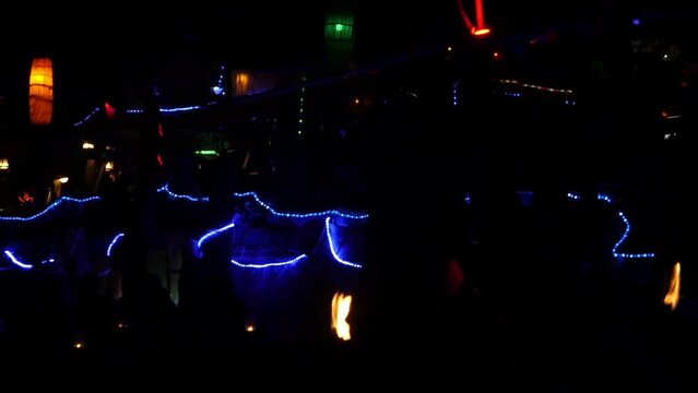 man doing a show with burning bolas in thailand