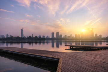 Obraz premium Sunrise Over Cityscape with Boardwalk