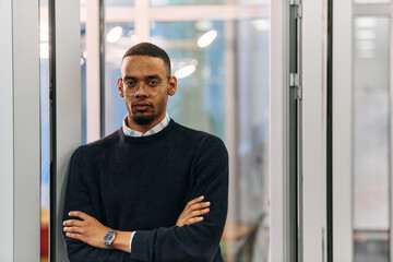 African-American Businessman Posing with Crossed Arms in Modern Office