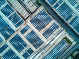 industrial sustainability aerial view of expansive warehouse roof covered in gleaming solar panels symbolizing green energy adoption