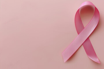 Supporting Breast Cancer awareness concept. Pink ribbon isolated on pastel pink background with space for text. World cancer day