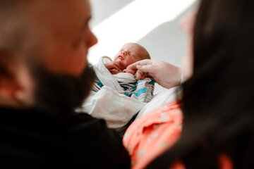 Couple with newborn baby in the hospital