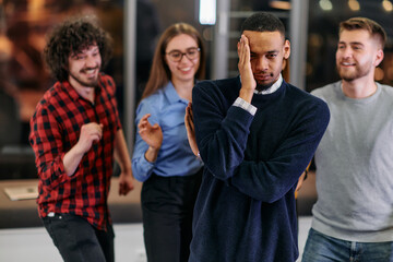 Fototapeta premium A group of young business people have fun playing interesting games while taking a break from work in a modern office. Selective focus 