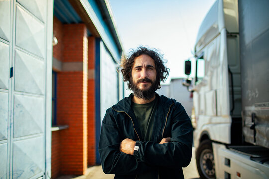 Portrait of a confident middle aged male truck driver at truck stop