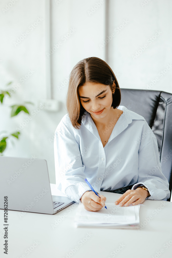 Sticker Young woman working at desk in modern office