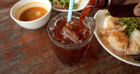 Traditional ice black tea is local beverage in Thailand.