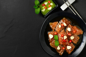 Top view of Pickled Salmon with Soy Sauce, chilli and garlic