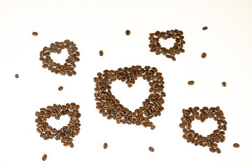 A collection of coffee beans arranged in the shape of hearts