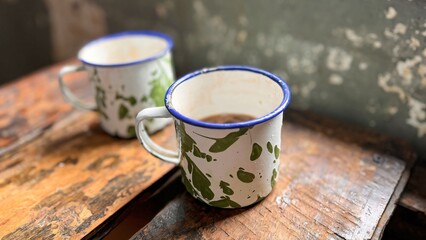 The old tin cup utensils on the table in the Asian prison ward, local called as cangkir blirik, drinking tin cup used in Asian prisons some old days