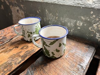 The old tin cup utensils on the table in the Asian prison ward, local called as cangkir blirik, drinking tin cup used in Asian prisons some old days