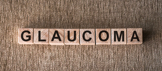 Medical Concept Glaucoma Spelled Out on Wooden Blocks on a Textured Surface