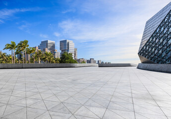 Fototapeta premium Empty square floor with modern city buildings scenery. car background.