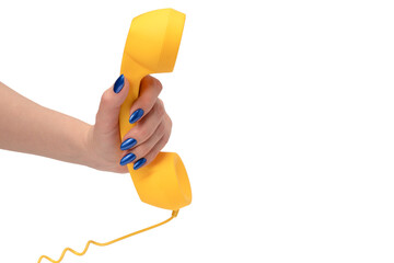 Yellow handset in woman hand isolated on white. Copy space.
