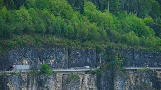 Semi-Truck Driving on a Mountain Highway During Spring