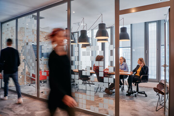 In the dynamic hustle and bustle of a business environment, a group of young business professionals...