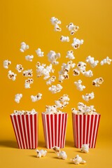 popcorn flying out of red and white striped cinema boxes on a yellow background