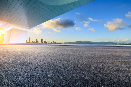Asphalt road and bridge with city skyline at sunset in Shenzhen. car advertising background.