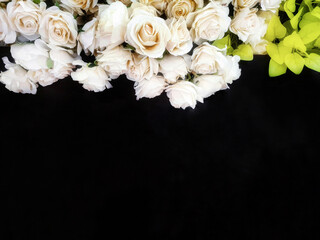 White roses flower decoration on dark background. Artificial flowers. Space for text.